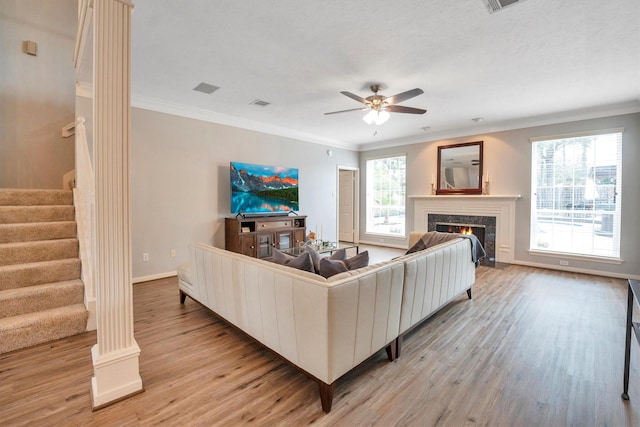 7318 Starbridge Dr, Houston, TX 77095 - living room featuring stairway, ceiling fan, ornamental molding, a premium fireplace, and light wood-style floors