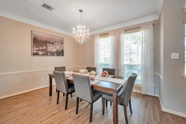 7318 Starbridge Dr, Houston, TX 77095 - dining area with ornamental molding, light wood-style floors, a chandelier, baseboards, and healthy amount of natural light