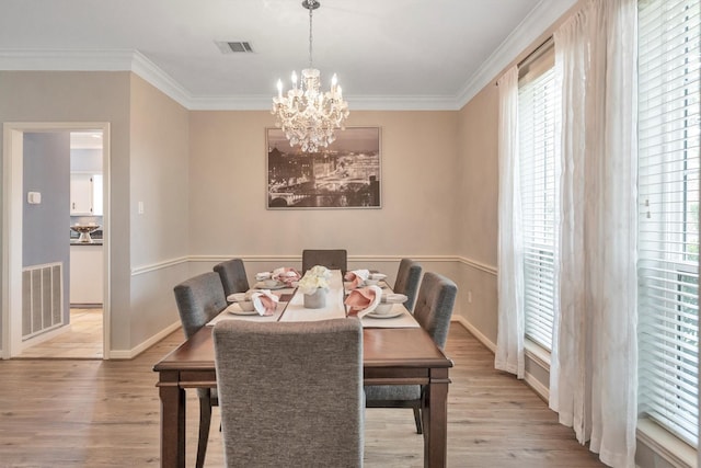 7318 Starbridge Dr, Houston, TX 77095 - dining room featuring light wood-style floors, crown molding, a chandelier, and baseboards
