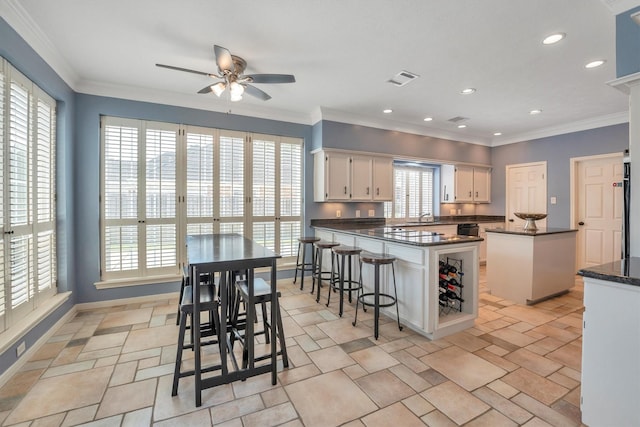 7318 Starbridge Dr, Houston, TX 77095 - kitchen with a ceiling fan, a peninsula, white cabinets, recessed lighting, and a sink