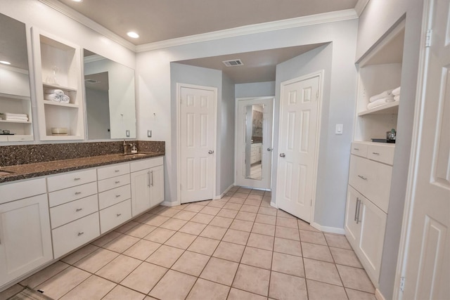 7318 Starbridge Dr, Houston, TX 77095 - bathroom with crown molding, baseboards, double vanity, tile patterned floors, and recessed lighting