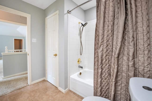 7318 Starbridge Dr, Houston, TX 77095 - bathroom featuring toilet, shower / tub combo with curtain, baseboards, and tile patterned floors