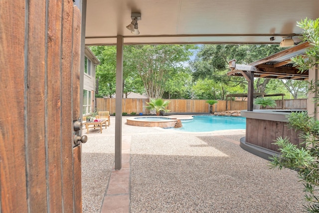7318 Starbridge Dr, Houston, TX 77095 - view of swimming pool featuring a fenced backyard, a patio area, and a pool with connected hot tub