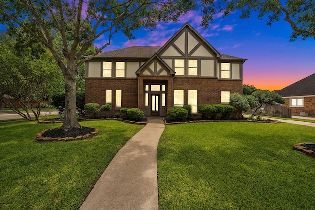 7318 Starbridge Dr, Houston, TX 77095 - tudor-style house featuring a lawn, stucco siding, and brick siding