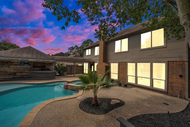 7318 Starbridge Dr, Houston, TX 77095 - pool at dusk featuring a patio and a pool with connected hot tub