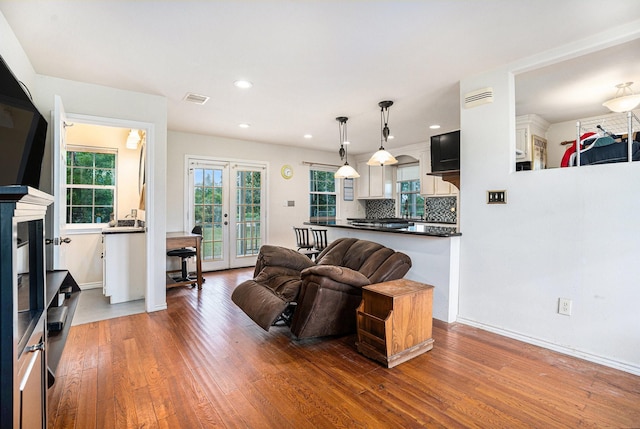 4201 Lawrence Rd, Beach City, TX 77523 - living area featuring wood finished floors, healthy amount of natural light, french doors, recessed lighting, and baseboards