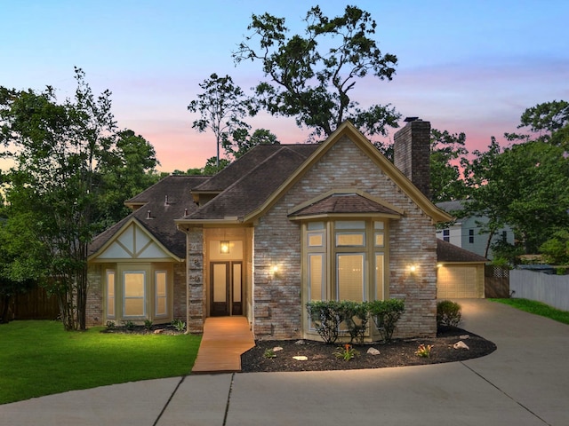 489 Merrimac Park, Conroe, TX 77302 - view of front of house with a chimney, a detached garage, brick siding, and a shingled roof