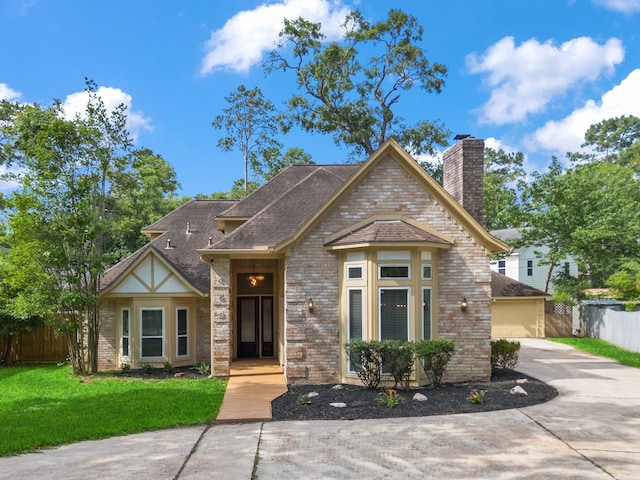 489 Merrimac Park, Conroe, TX 77302 - view of front of house with brick siding, a chimney, and roof with shingles