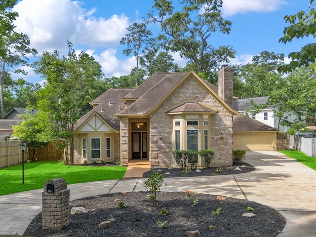 489 Merrimac Park, Conroe, TX 77302 - view of front of house with a chimney, brick siding, roof with shingles, and a garage