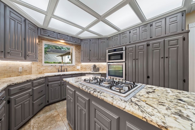489 Merrimac Park, Conroe, TX 77302 - kitchen featuring gray cabinets, gas cooktop, light stone counters, and a sink