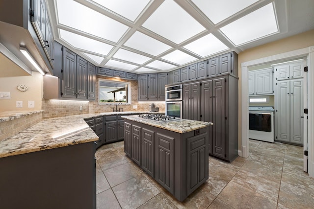 489 Merrimac Park, Conroe, TX 77302 - kitchen featuring stainless steel appliances, gray cabinetry, tasteful backsplash, and a sink