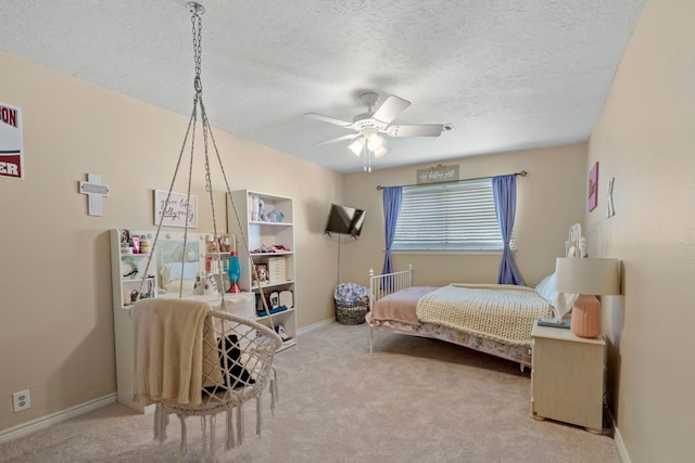 489 Merrimac Park, Conroe, TX 77302 - bedroom with carpet floors, a textured ceiling, baseboards, and ceiling fan
