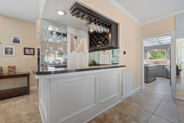 489 Merrimac Park, Conroe, TX 77302 - indoor bar with a textured ceiling, crown molding, and baseboards