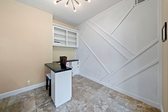 489 Merrimac Park, Conroe, TX 77302 - unfurnished office with a decorative wall, baseboards, and a textured ceiling