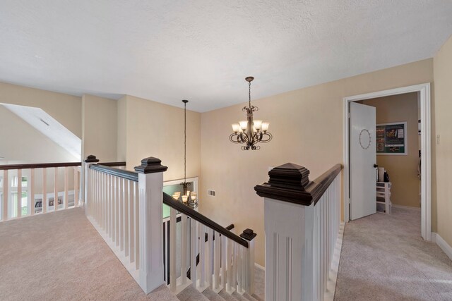 489 Merrimac Park, Conroe, TX 77302 - hall with a chandelier, carpet floors, an upstairs landing, and baseboards