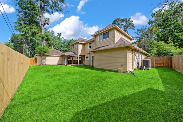 489 Merrimac Park, Conroe, TX 77302 - back of house with central air condition unit and a shingled roof