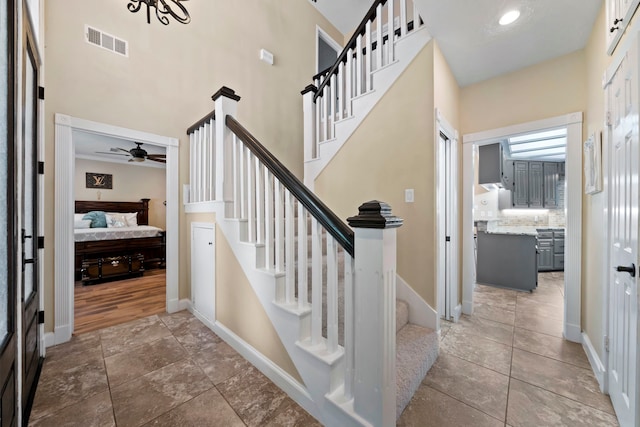 489 Merrimac Park, Conroe, TX 77302 - stairway featuring a towering ceiling, a ceiling fan, and baseboards