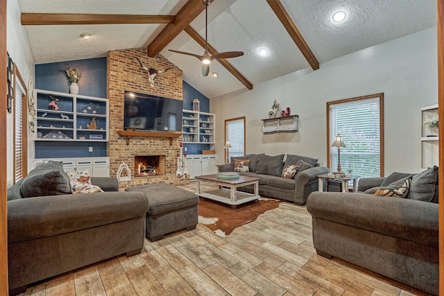 660 Hillcrest Dr, Huntsville, TX 77340 - living area featuring a textured ceiling, wood finished floors, ceiling fan, a brick fireplace, and built in features