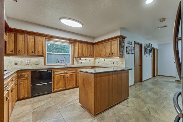 660 Hillcrest Dr, Huntsville, TX 77340 - kitchen with a sink, brown cabinetry, black dishwasher, backsplash, and a textured ceiling