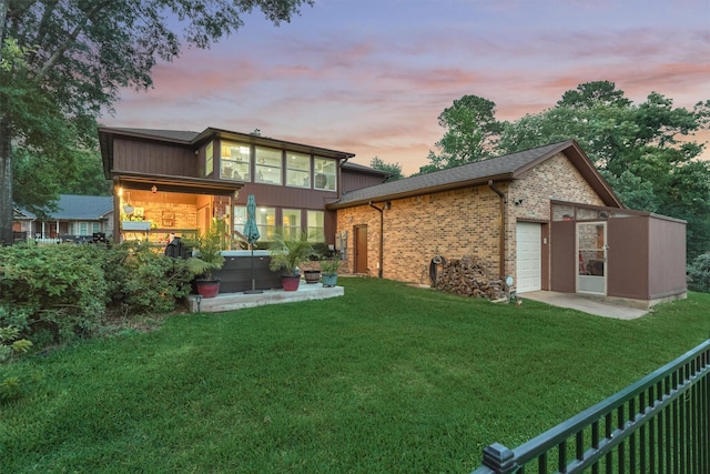 660 Hillcrest Dr, Huntsville, TX 77340 - back of property featuring a yard, a garage, and brick siding