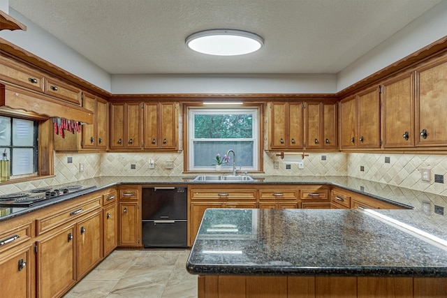 660 Hillcrest Dr, Huntsville, TX 77340 - kitchen featuring a sink, black appliances, brown cabinetry, tasteful backsplash, and dark stone countertops