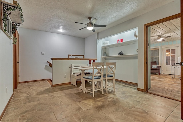 660 Hillcrest Dr, Huntsville, TX 77340 - dining room with ceiling fan, baseboards, and a textured ceiling