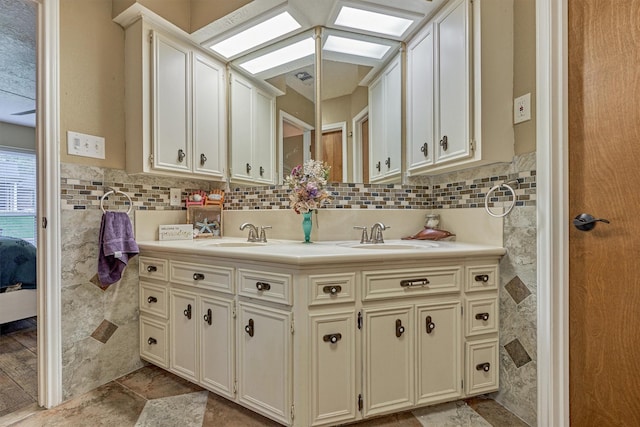 660 Hillcrest Dr, Huntsville, TX 77340 - full bathroom with a skylight, double vanity, connected bathroom, and tile walls