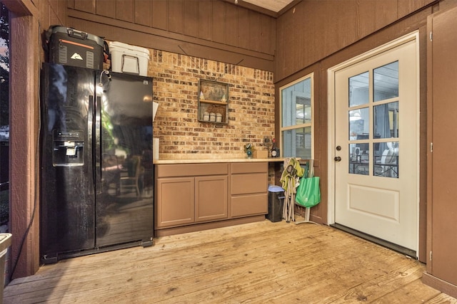 660 Hillcrest Dr, Huntsville, TX 77340 - kitchen with black fridge, light wood finished floors, and light countertops