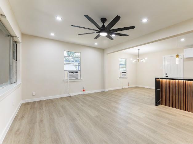 1848 Kipling St, Liberty, TX 77575 - unfurnished room with light wood finished floors, a ceiling fan, recessed lighting, a chandelier, and baseboards