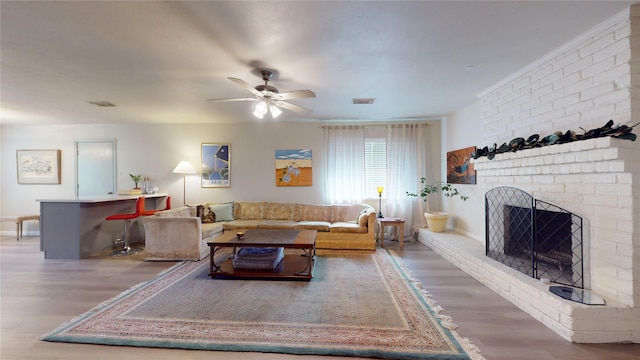 9723 Dalmally St, Spring, TX 77379 - living room with wood finished floors, a ceiling fan, a brick fireplace, and baseboards