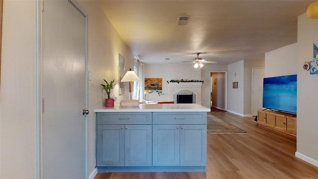 9723 Dalmally St, Spring, TX 77379 - kitchen featuring ceiling fan, light wood-style floors, a peninsula, and baseboards