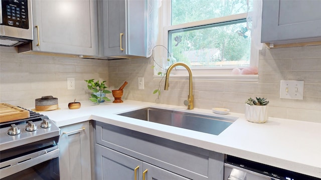 9723 Dalmally St, Spring, TX 77379 - kitchen featuring a sink, stainless steel appliances, and gray cabinets