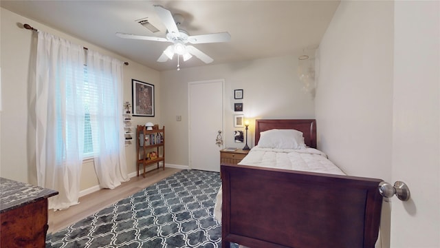 9723 Dalmally St, Spring, TX 77379 - bedroom featuring wood finished floors, a ceiling fan, and baseboards