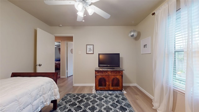 9723 Dalmally St, Spring, TX 77379 - bedroom with light wood-style floors, baseboards, and ceiling fan
