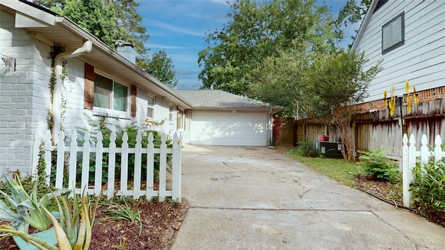 9723 Dalmally St, Spring, TX 77379 - view of side of home featuring a chimney, concrete driveway, and a garage