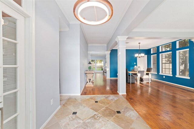 16919 Shady Square Ct, Houston, TX 77095 - foyer entrance with decorative columns, crown molding, a chandelier, baseboards, and wood finished floors