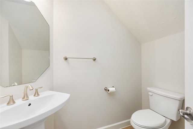 17311 Morgans Lake Dr, Cypress, TX 77433 - half bath featuring a sink, lofted ceiling, toilet, and baseboards