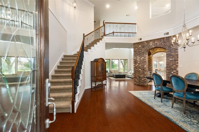 17311 Morgans Lake Dr, Cypress, TX 77433 - foyer with a towering ceiling, stairs, arched walkways, wood-type flooring, and a chandelier