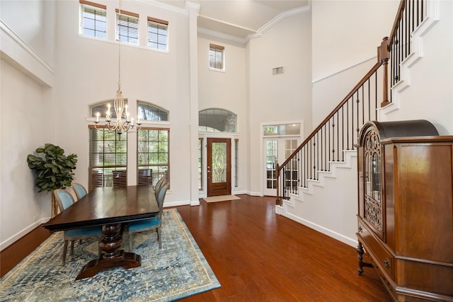17311 Morgans Lake Dr, Cypress, TX 77433 - entrance foyer with a chandelier, crown molding, a towering ceiling, dark wood-style flooring, and baseboards