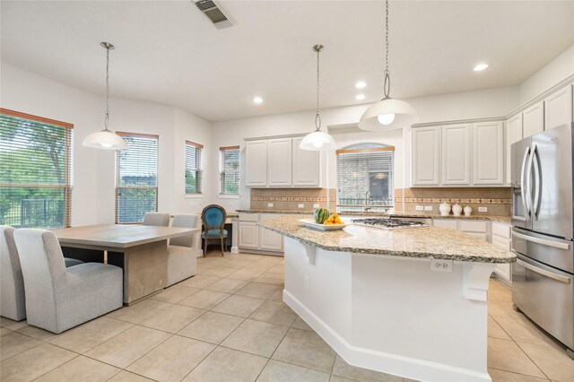 17311 Morgans Lake Dr, Cypress, TX 77433 - kitchen with stainless steel fridge with ice dispenser, light tile patterned floors, recessed lighting, decorative backsplash, and white cabinets