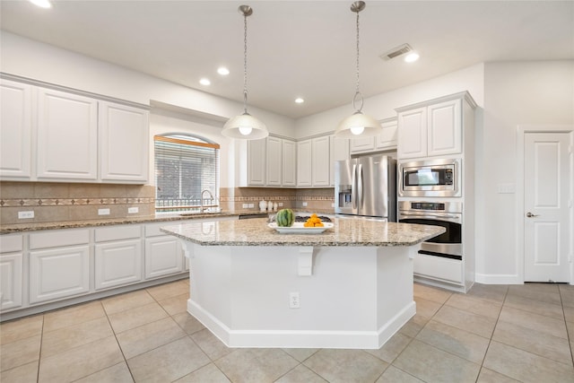 17311 Morgans Lake Dr, Cypress, TX 77433 - kitchen with appliances with stainless steel finishes, decorative backsplash, a sink, light tile patterned flooring, and recessed lighting