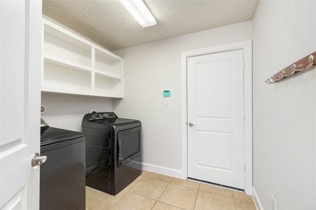 17311 Morgans Lake Dr, Cypress, TX 77433 - washroom with independent washer and dryer, light tile patterned floors, baseboards, and a textured ceiling