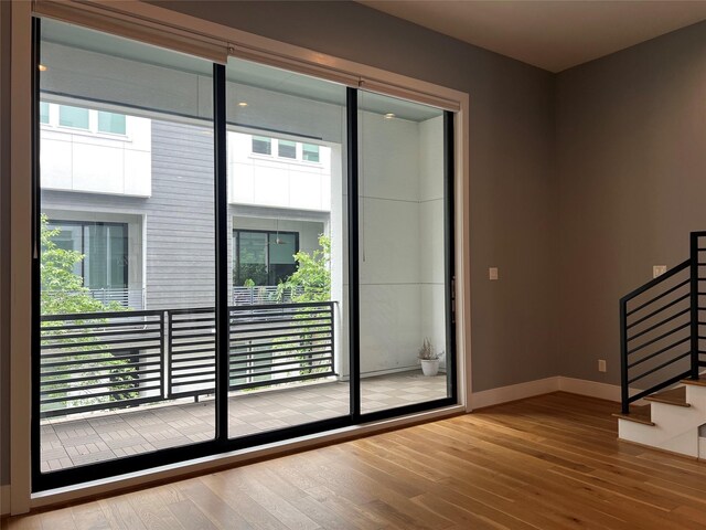 2620 Rusk St, Houston, TX 77003 - doorway featuring wood-type flooring, baseboards, and stairway