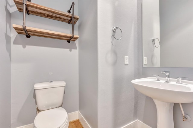 2620 Rusk St, Houston, TX 77003 - half bathroom with toilet, baseboards, and a sink