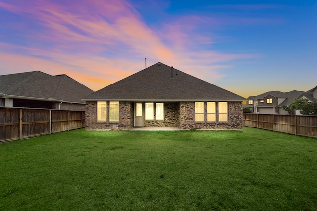 27130 Spanish Wind Ct, Magnolia, TX 77354 - back of property at dusk featuring a patio area, brick siding, and a shingled roof