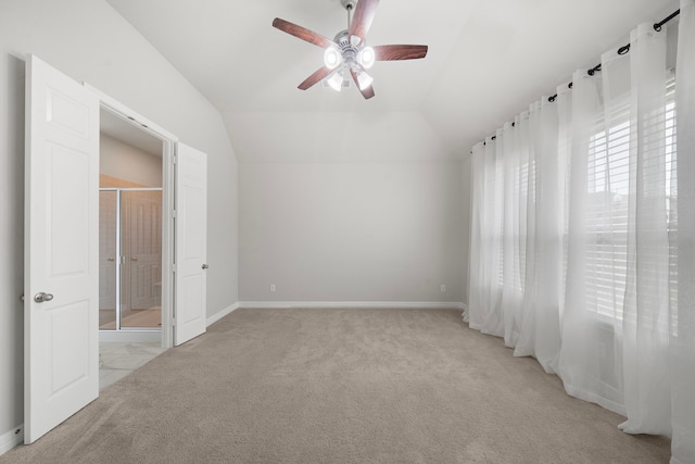 27130 Spanish Wind Ct, Magnolia, TX 77354 - spare room featuring light colored carpet, a ceiling fan, vaulted ceiling, and baseboards