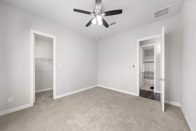 27130 Spanish Wind Ct, Magnolia, TX 77354 - unfurnished bedroom with carpet floors, a spacious closet, baseboards, a ceiling fan, and a closet