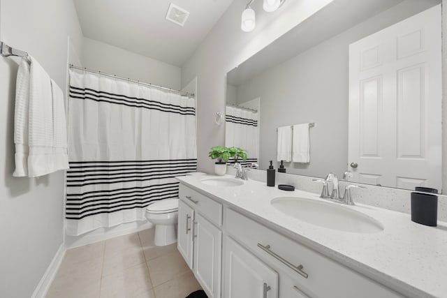 27130 Spanish Wind Ct, Magnolia, TX 77354 - full bath featuring double vanity, toilet, tile patterned floors, and baseboards