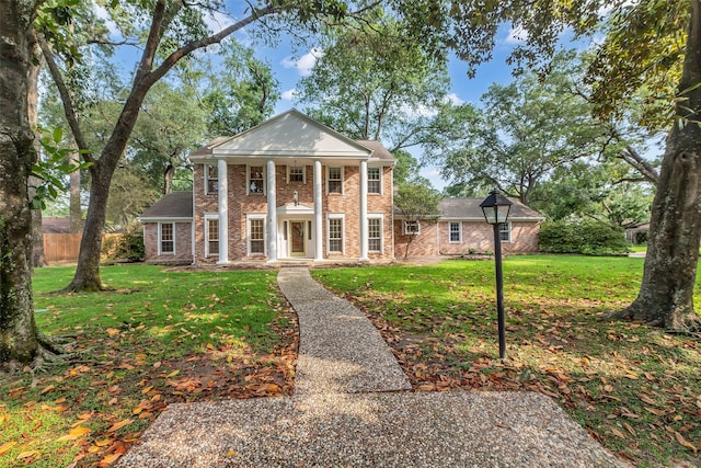 13631 Balmore Cir, Houston, TX 77069 - neoclassical home featuring a porch, a front yard, and brick siding