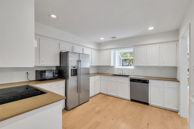 13631 Balmore Cir, Houston, TX 77069 - kitchen featuring black appliances, a sink, backsplash, white cabinetry, and recessed lighting